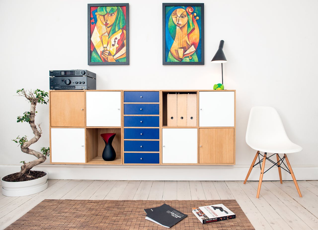about-us-01 Contemporary room design featuring colorful artwork, sleek furniture, and decorative elements.